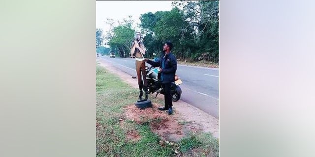 Two men face charges after allegedly pretending to bribe a cardboard cutout of a traffic cop in Sri Lanka. (Vavuniya Police)