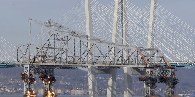 A section of the old Tappan Zee Bridge is brought down with explosives in this view from Tarrytown, N.Y., Tuesday, Jan. 15, 2019. (AP Photo/Seth Wenig)