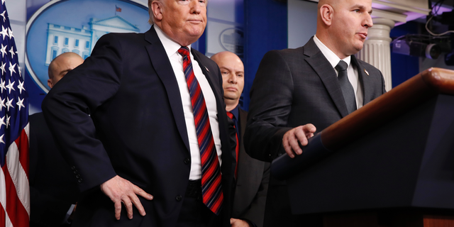 President Donald Trump, left, listens as Brandon Judd, president of the National Border Patrol Council, talks about border security, Thursday Jan. 3, 2019, after making a surprise visit to the press briefing room of the White House in Washington. (AP Photo/Jacquelyn Martin)