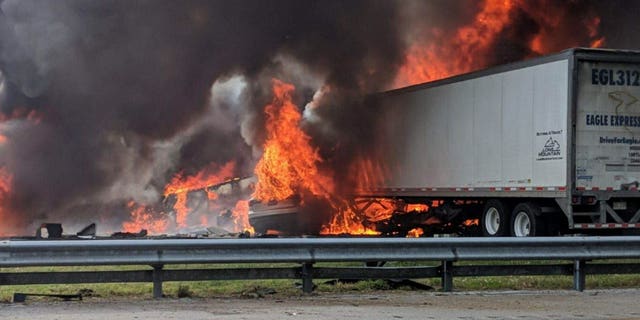 Flames engulf vehicles after a fiery crash along Interstate 75, Thursday, Jan. 3, 2019, about a mile south of Alachua, near Gainesville, Fla. Highway officials say at least six people have died after a crash and diesel fuel spill sparked a massive fire along the Florida interstate.