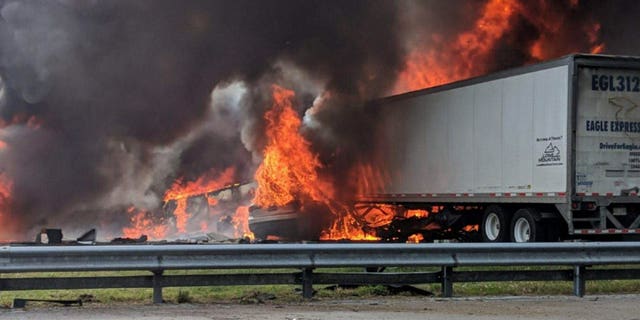 Flames engulf vehicles after a fiery crash along Interstate 75, Thursday, Jan. 3, 2019, about a mile south of Alachua, near Gainesville, Fla. Highway officials say at least six people have died after a crash and diesel fuel spill sparked a massive fire along the Florida interstate.