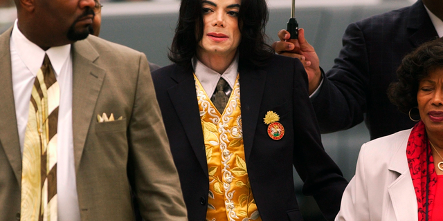 FILE - In this May 25, 2005 file photo, Michael Jackson arrives at the Santa Barbara County Courthouse for his child molestation trial in Santa Maria, Calif.
