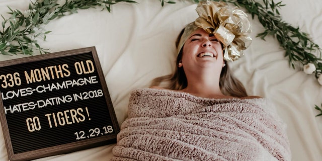 "336 months old. Loves: Champagne, Hates: Dating in 2018 - Go Tigers!" a black-and-white letter board artfully posed next to Ham reads.
