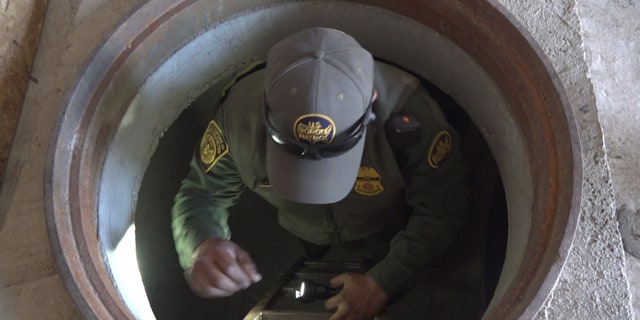 A Border Patrol agent demonstrates climbing into and out of the mock tunnels used for training at the Border Patrol Tucson Sector Nogales Station.
