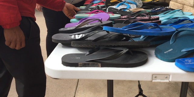 A migrant chooses from a selection of donated shoes at Longview Community Church