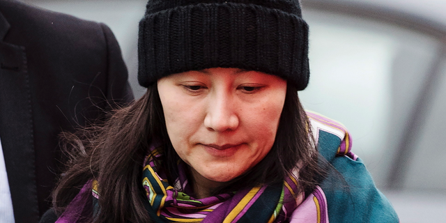 In this Dec. 12, 2018, file photo, Huawei chief financial officer Meng Wanzhou arrives at a parole office with a security guard in Vancouver, British Columbia. China on Tuesday, Jan. 22, 2019, demanded the U.S. drop a request that Canada extradite the top executive of the tech giant Huawei.