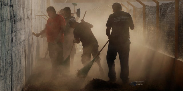 Migrants from Central America receiving humanitarian visas from Mexico are working to pay for cleaning a public sports stadium , which is being prepared to be used as shelter for migrants entering Ciudad Hidalgo, Chiapas, Mexico, on Monday, January 21, 2019, at the Guatemalan border, with thousands of Central American immigrants expecting Mexican officials to issue humanitarian visas to Mexico, allowing them to be in Mexico one year and work legally. (AP Photo / Marco Ugarte)