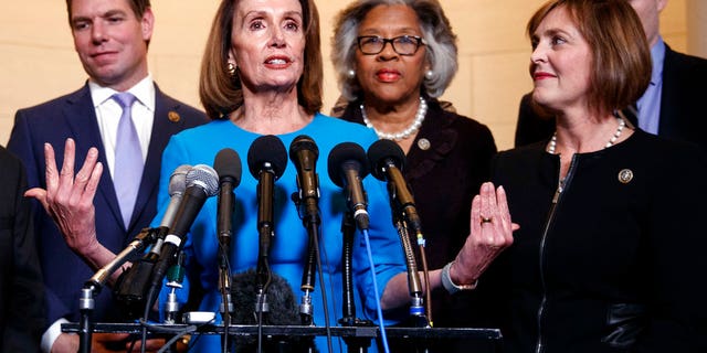 FILE - In this Nov. 28, 2018, file photo, House Minority Leader Nancy Pelosi, D-Calif., joined by from left, Rep. Eric Swalwell, D-Calif., Rep. Joyce Beatty, D-Ohio., and Rep. Kathy Castor, D-Fla., speaks to media at Longworth House Office Building on Capitol Hill in Washington, Wednesday, to announce her nomination by House Democrats to lead them in the new Congress. Pelosi has appointed Castor to lead a special committee on climate change that replaces one eliminated by Republicans in 2011. (AP Photo/Carolyn Kaster, File)