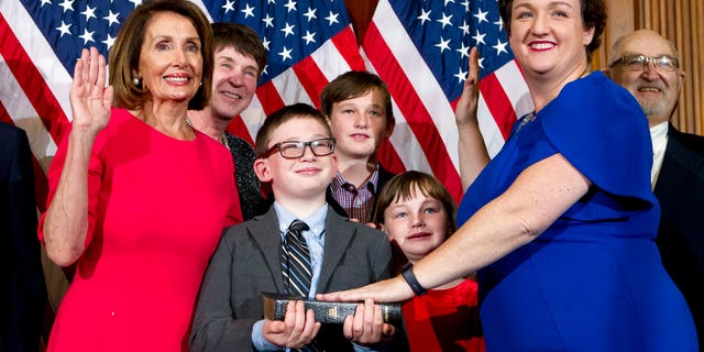 House Speaker Nancy Pelosi of Calif., administers the House oath of office to Rep. Katie Porter, D-Calif., during ceremonial swearing-in on Capitol Hill in Washington, Thursday, Jan. 3, 2019, during the opening session of the 116th Congress. (AP Photo/Jose Luis Magana)