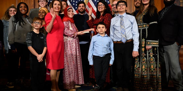 House Speaker Nancy Pelosi of Calif., poses during a ceremonial swearing-in with Rep. Rashida Tlaib, D-Mich., sixth from right, on Capitol Hill in Washington, Thursday, Jan. 3, 2019, during the opening session of the 116th Congress. (AP Photo/Susan Walsh)