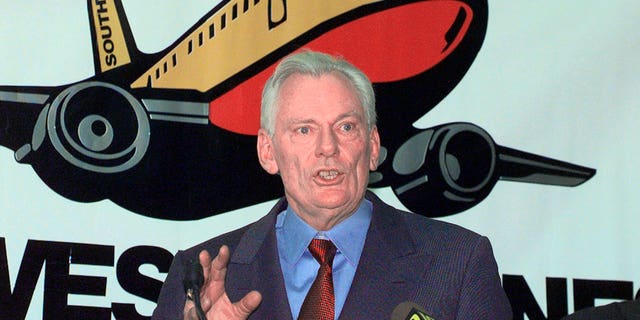 FILE - In this Dec. 9, 1998, file photo, Southwest Airlines President and CEO Herb Kelleher speaks at a news conference at MacArthur Airport in Islip, N.Y. Not many CEOs dress up as Elvis Presley, settle a business dispute with an arm-wrestling contest, or go on TV wearing a paper bag over their head. Southwest confirmed Kelleher died on Thursday, Jan. 3, 2019. He was 87. (AP Photo/Ed Betz, File)