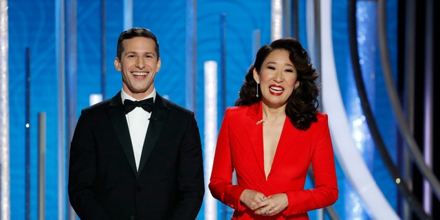 This image released by NBC shows hosts Andy Samberg, left, and Sandra Oh at the 76th Annual Golden Globe Awards at the Beverly Hilton Hotel on Sunday, Jan. 6, 2019,.