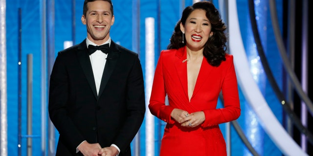 This image released by NBC shows hosts Andy Samberg, left, and Sandra Oh at the 76th Annual Golden Globe Awards at the Beverly Hilton Hotel on Sunday, Jan. 6, 2019,.