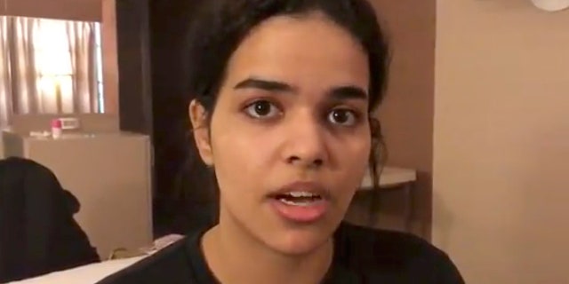In this Monday, Jan. 7, 2019, image made from video released by Rahaf Mohammed Alqunun/Human Rights Watch, Rahaf Mohammed Alqunun views her mobile phone as she sits barricaded in a hotel room at an international airport in Bangkok, Thailand. Alqunun says she is fleeing abuse by her family and wants asylum in Australia. (Rahaf Mohammed Alqunun/Human Rights Watch via AP)