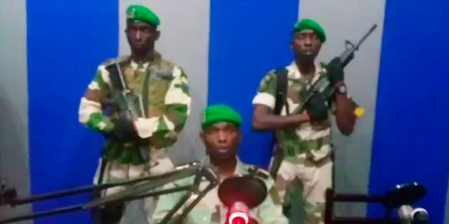 A soldier who identified himself as Lt. Obiang Ondo Kelly, commander of the Republican Guard, reads a statement on state television broadcast from Libreville, saying the military has seized control of the government. (