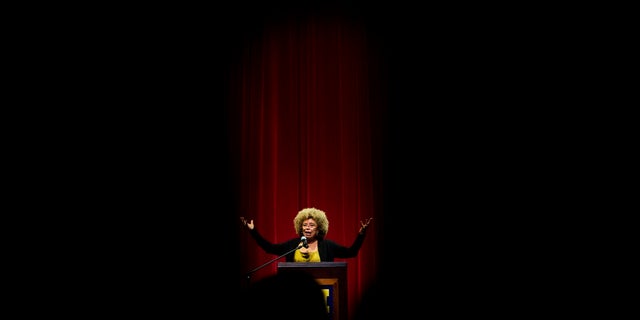 Angela Davis, author, educator and iconic civil rights activist, speaks during her visit to the University of Michigan-Flint, in Flint, Mich. (Jake May/The Flint Journal via AP, File)