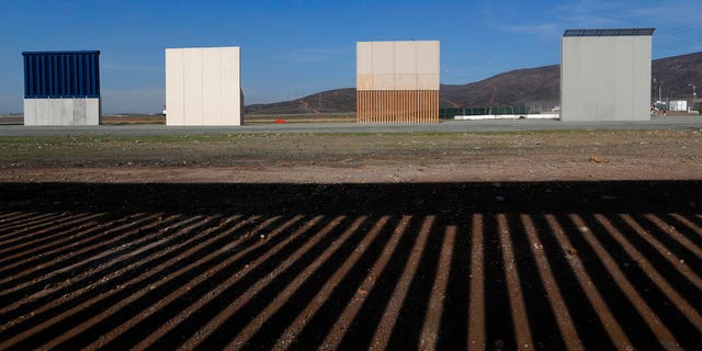 FILE - In this Wednesday, Dec. 12, 2018, file photo, border wall prototypes stand in San Diego near the Mexico-U.S. border, seen from Tijuana, Mexico, where the current wall casts a shadow in the foreground. (AP Photo/Moises Castillo, File)