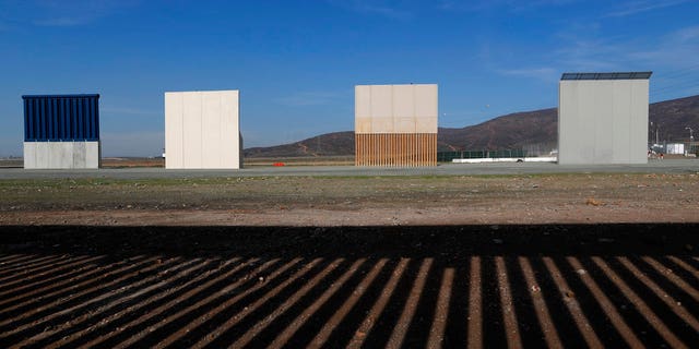 FILE - In this Wednesday, Dec. 12, 2018, file photo, border wall prototypes stand in San Diego near the Mexico-U.S. border, seen from Tijuana, Mexico, where the current wall casts a shadow in the foreground. (AP Photo/Moises Castillo, File)