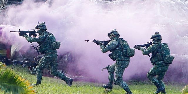 FILE: Soldiers from Taiwan's special forces move through colored smoke during a military exercise in Taipei, Taiwan.