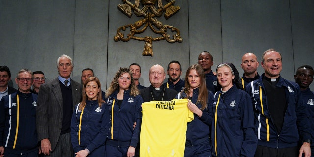 From left, CONI Italian Olympic Committee President Giovanni Malago', Cardinal Gianfranco Ravasi, President of the Pontifical Council for Culture and Melichor Jose' Sanchez de Toca y Alameda, right, pose for photos at the end of a press conference, at the Vatican.