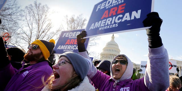On the 20th day of a partial government shutdown, federal employees rally at the Capitol to protest the impasse between Congress and President Donald Trump over his demand to fund a U.S.-Mexico border wall, in Washington, Thursday, Jan. 10, 2019. (AP Photo/J. Scott Applewhite)