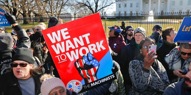 Union members and other federal employees stop in front of the White House in Washington during a rally to call for an end to the partial government shutdown, Thursday, Jan. 10, 2019. (AP Photo/Pablo Martinez Monsivais)