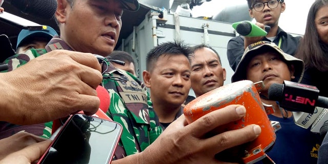 Indonesian Navy Commander Rear Admiral Yudo Margin shows the recovered cockpit voice recorder of Lion Air flight 610 that crashed into the sea in October during a press conference on board of the navy ship KRI Spica in the waters off Tanjung Karawang, Indonesia, Monday, Jan. 14, 2019. Navy divers have recovered the cockpit voice recorder in a possible boost to the accident investigation. (AP Photo/Achmad Ibrahim)