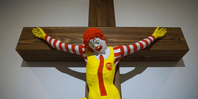 An artwork called "McJesus," which was sculpted by Finnish artist Jani Leinonen and depicts a crucified Ronald McDonald, is seen on display as part of the Haifa museum's "Sacred Goods" exhibit, in Haifa, Israel, Monday, Jan. 14, 2019. Hundreds of Christians calling for the sculpture's removal protested at the museum last week. (AP Photo/Oded Balilty)