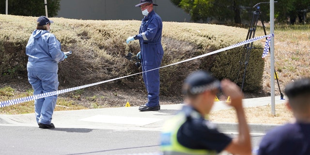 In this Wednesday, Jan. 16, 2019, photo, police investigators work at the scene where the body of Israeli student Aiia Maasarwe was found in Melbourne, Australia. Australian police are looking for at least one attacker who killed the Israeli woman as she was walking on a city street speaking to her sister by phone.