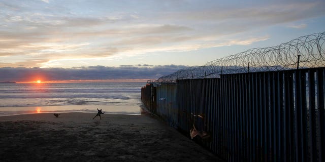 The border wall topped with razor wire in Tijuana, Mexico, earlier this month. (AP Photo/Gregory Bull, File)