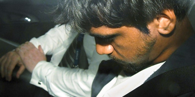 A 20-year-old man sits in a police car, Friday, Jan. 18, 2019, after he was arrested for questioning over the death of Israeli student Aiia Maasarwe in Melbourne, Australia. Maasarwe, a 21-year-old student, was slain at 12:10 a.m. on Wednesday shortly after she got off a tram, according to police.