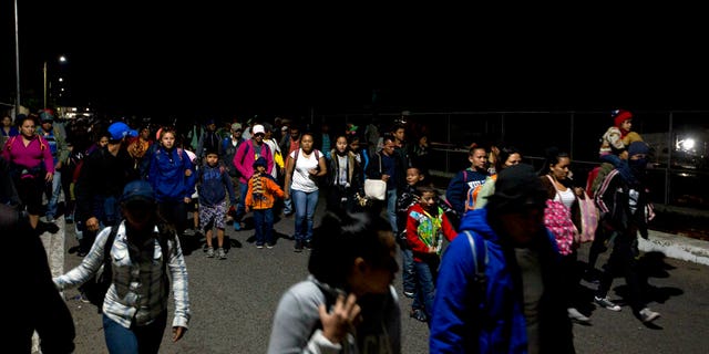 Honduras migrants walk cross the border bridge between Mexico and Guatemala without authorities registration in Ciudad Hidalgo, Mexico, Friday, Jan. 18, 2019.