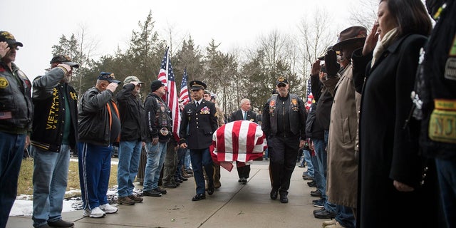 Pallbearers carry the casket of Vietnam veteran Peter Turnpu as several hundred gather for a funeral Friday, Jan. 18, 2019 in Wrightstown, N.J. (Associated Press)