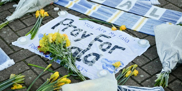 Flowers and tributes are placed outside the offices of Cardiff City Football Club, Wales, Jan. 23, 2019, after a plane with new signee Emiliano Sala on board went missing over the English Channel on Monday night.