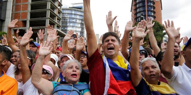 Anti-government protesters cheer after Juan Guaido, head of Venezuela's opposition-run congress, declares himself interim president of the South American country until new elections can be called, at a rally demanding the resignation of President Nicolas Maduro, in Caracas, Venezuela, Wednesday, Jan. 23, 2019.