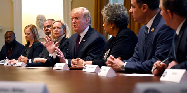 President Donald Trump, center, speaks in the Cabinet Room of the White House in Washington, Wednesday, Jan. 23, 2019, as he hosts a roundtable with conservative leaders to discuss the security and humanitarian crisis at the southern border. (AP Photo/Susan Walsh)