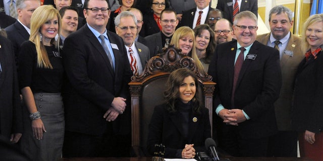 Gov. Kristi Noem smiles after signing her first bill into law at the state Capitol in Pierre, S.D., Thursday, Jan. 31, 2019. The measure allows people to carry concealed pistols without a permit in the state. (Associated Press)