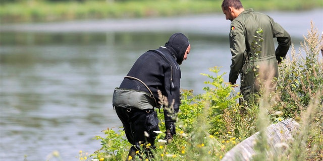 A diver gets out of the canal in Ronquieres, some 20 miles south of Brussels on August 3, 2010 during a search for evidence in the "Brabant's killers" case.