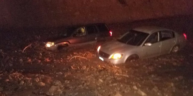 Vehicles became trapped on the Pacific Coast Highway after mudslides on Saturday due to heavy rain in wildfire burn areas.