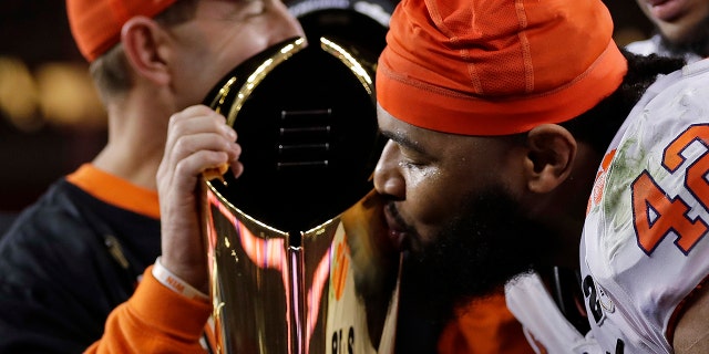 Clemson's Christian Wilkins kisses the trophy after the NCAA college football playoff championship game against Alabama, Monday, Jan. 7, 2019, in Santa Clara, Calif. Clemson beat Alabama 44-16.