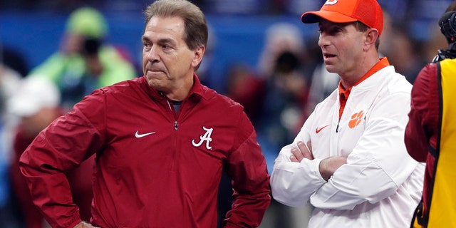 FILE - In this Jan. 1, 2018, file photo, Alabama head coach Nick Saban, left, and Clemson head coach Dabo Swinney talk before the Sugar Bowl semifinal playoff game for the NCAA college football national championship in New Orleans.