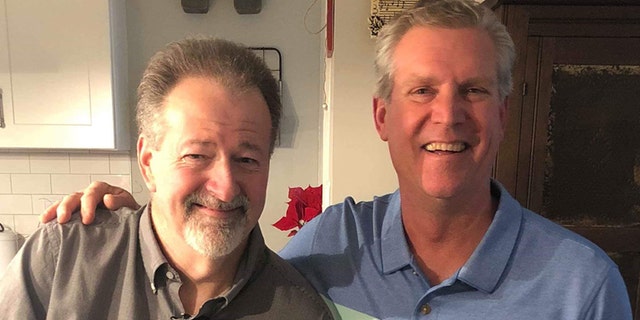 Mike Hodgin, left, considers his mailman, Chris Petersen, right, a hero after he saved his life on Christmas Eve. The two reunited on New Year's Day.