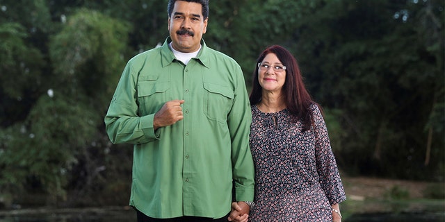 Venezuela's President Nicolas Maduro (L) and his wife and deputy of Venezuela's United Socialist Party (PSUV) pose for a photo during the recording of a government Christmas message in Caracas, Venezuela December 20, 2016.