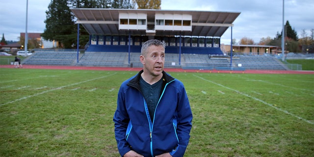 Former Bremerton High School assistant football coach Joe Kennedy stands at the center of the field on the 50 yard line at Bremerton Memorial Stadium, Nov. 5, 2015. (Larry Steagall/Kitsap Sun via AP)