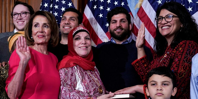 Rep. Rashida Tlaib (D-MI) poses with Speaker of the House Nancy Pelosi (D-CA) for a ceremonial swearing-in picture on Capitol Hill in Washington, U.S., January 3, 2019. REUTERS/Joshua Roberts - RC1717918ED0