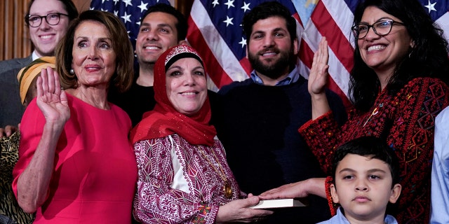 Rep. Rashida Tlaib (D-MI) poses with Speaker of the House Nancy Pelosi (D-CA) for a ceremonial swearing-in picture on Capitol Hill in Washington, U.S., January 3, 2019. REUTERS/Joshua Roberts - RC1717918ED0