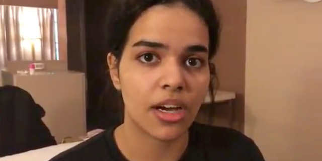 In this Monday, Jan. 7, 2019, image made from video released by Rahaf Mohammed Alqunun/Human Rights Watch, Rahaf Mohammed Alqunan views her mobile phone as she sits barricaded in a hotel room at an international airport in Bangkok, Thailand. Alqunan says she is fleeing abuse by her family and wants asylum in Australia. (Rahaf Mohammed Alqunun/Human Rights Watch via AP)