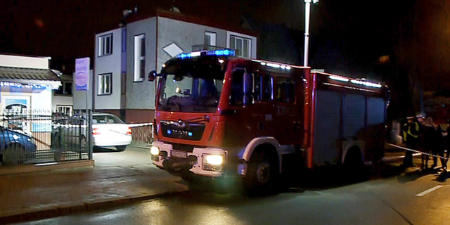 A fire engine stands outside an "Escape Room" game location in Koszalin, northern Poland, on Friday, Jan. 4, 2019. A fire broke out at the "Escape Room" game location, killing five teenage girls and injuring a man, authorities said. 0(AP Photo/TVN News via AP)