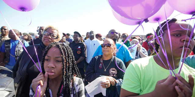 Zyriah Taylor, 11, left, and her cousin, Jaskya Lee-Mills, 13, attend a community rally for seven-year-old Jazmine Barnes on Saturday, Jan. 5, 2019 in Houston. Barnes was killed when a driver shot into the car she and her family were driving in last Sunday. (Melissa Phillip/Houston Chronicle via AP)