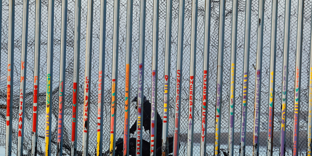 A Border Patrol agent rides a vehicle on the beach in San Diego, earlier this month, in a view through a border barrier from Tijuana, Mexico. (AP Photo/Gregory Bull)